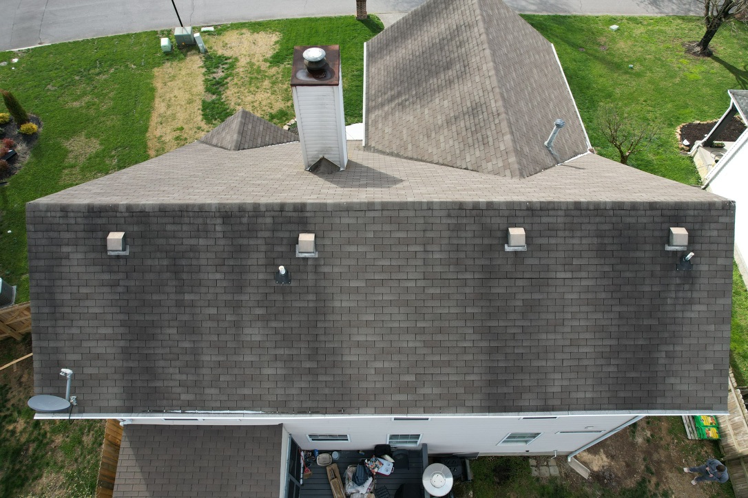 Before photo of new roof replacement in Fountain City, TN showing an older asphalt shingle roof from above.<br />
