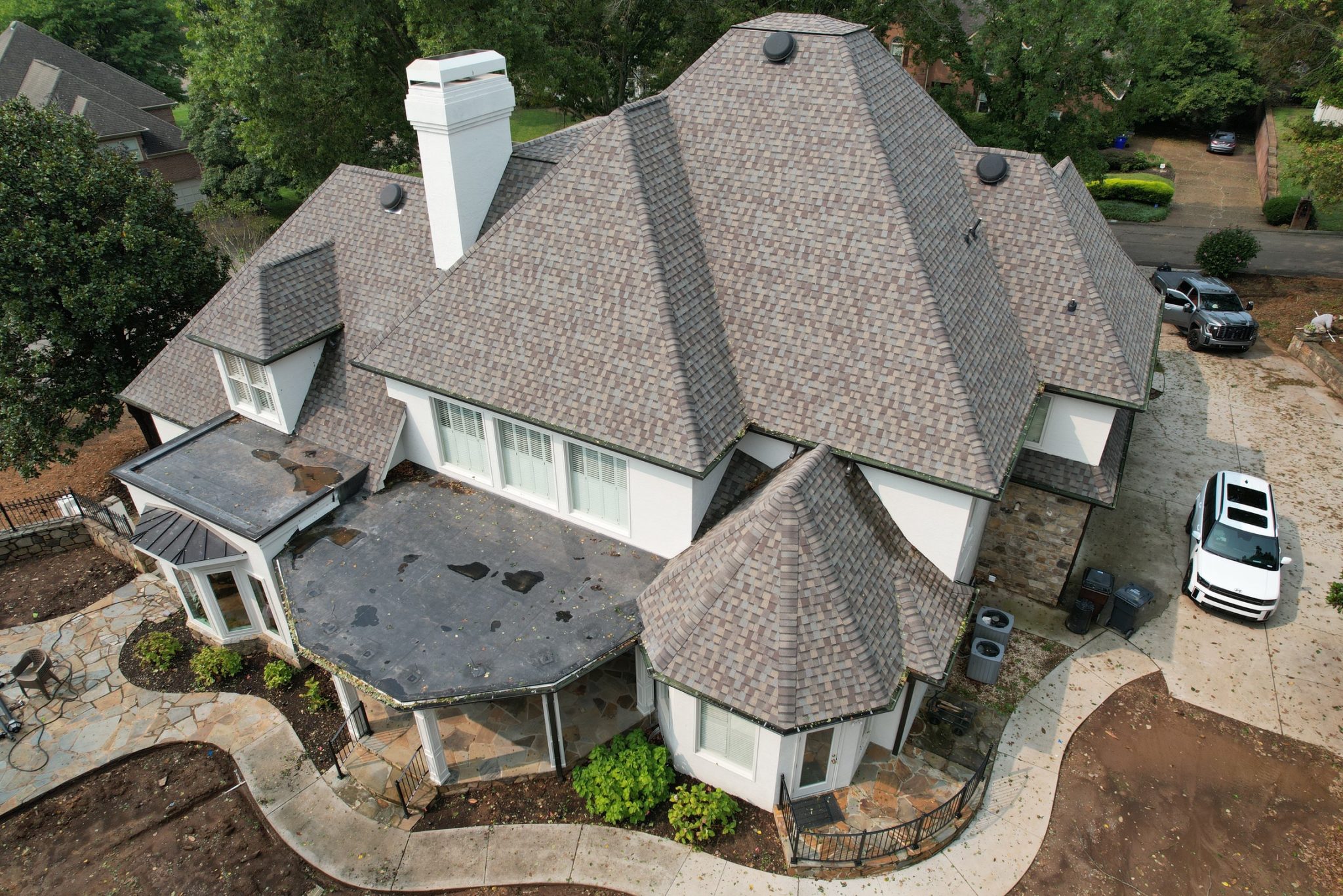 Asphalt Roof Replacement Cost Factors in Knoxville Drone view of a Knoxville home after asphalt roof replacement with architectural shingles on a multi-hip roof.