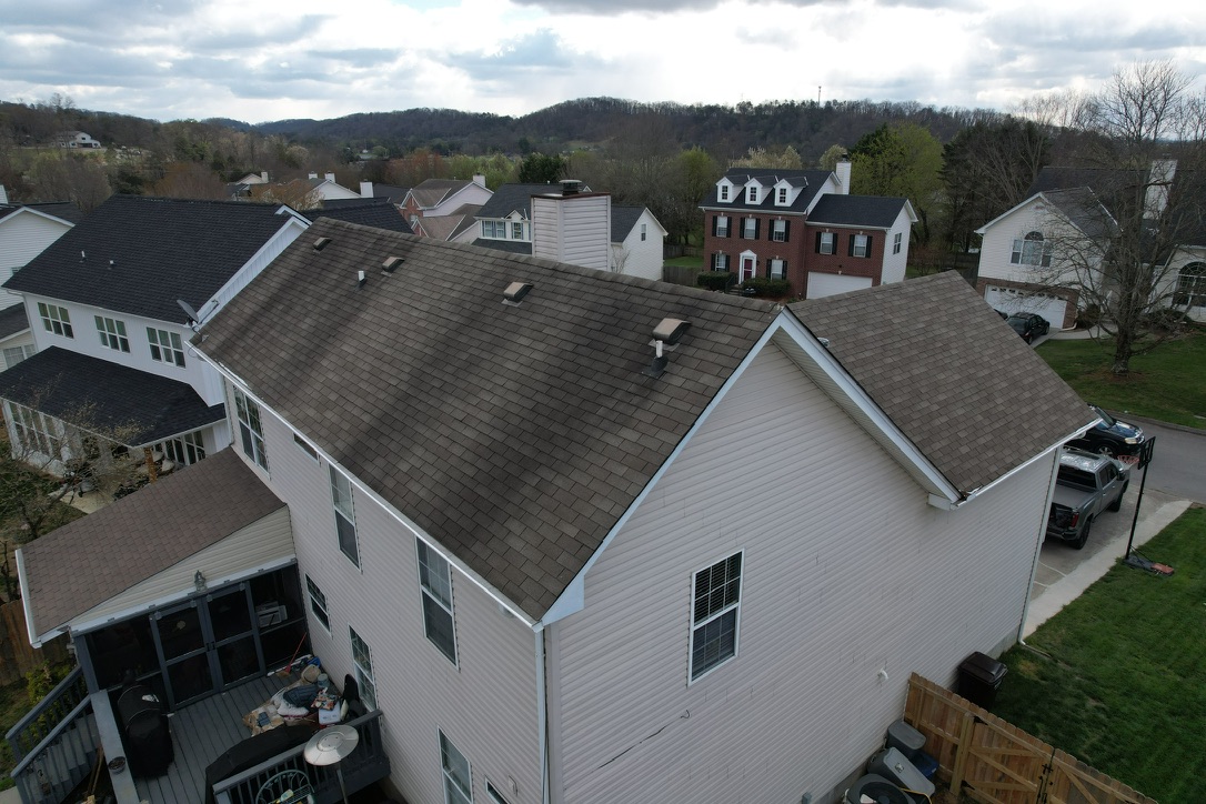 Before Side View Of New Roof Replacement In Fountain City, TN Before side view of new roof replacement in Fountain City, TN showing dark staining on the old asphalt roof.