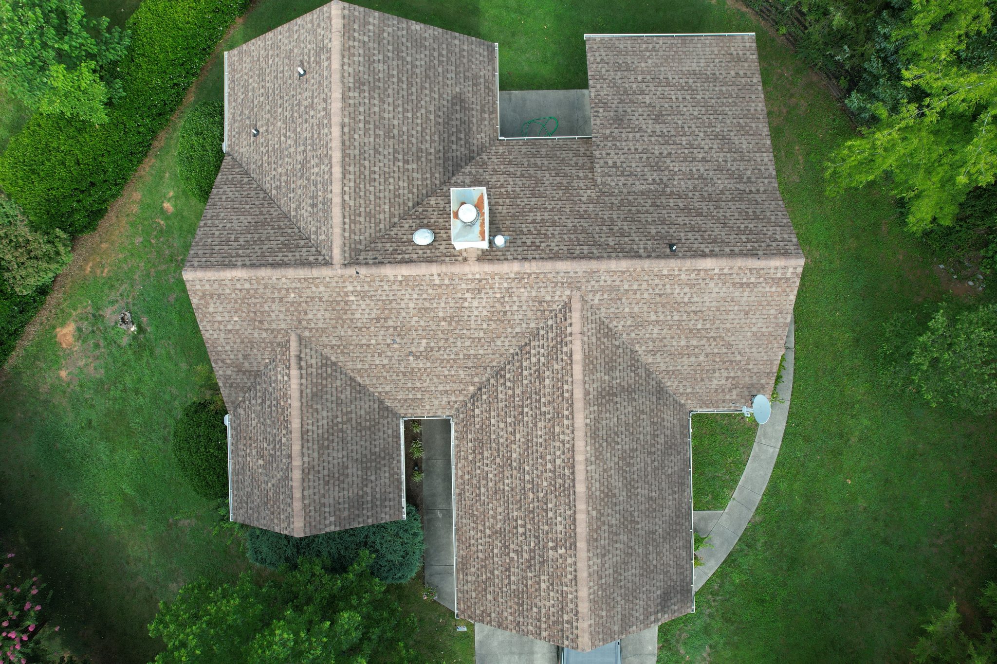 Before Maryville Roof Replacement Before a Maryville roof replacement, aerial view of an aging brown shingle roof with multiple hips, valleys, and roof penetrations.