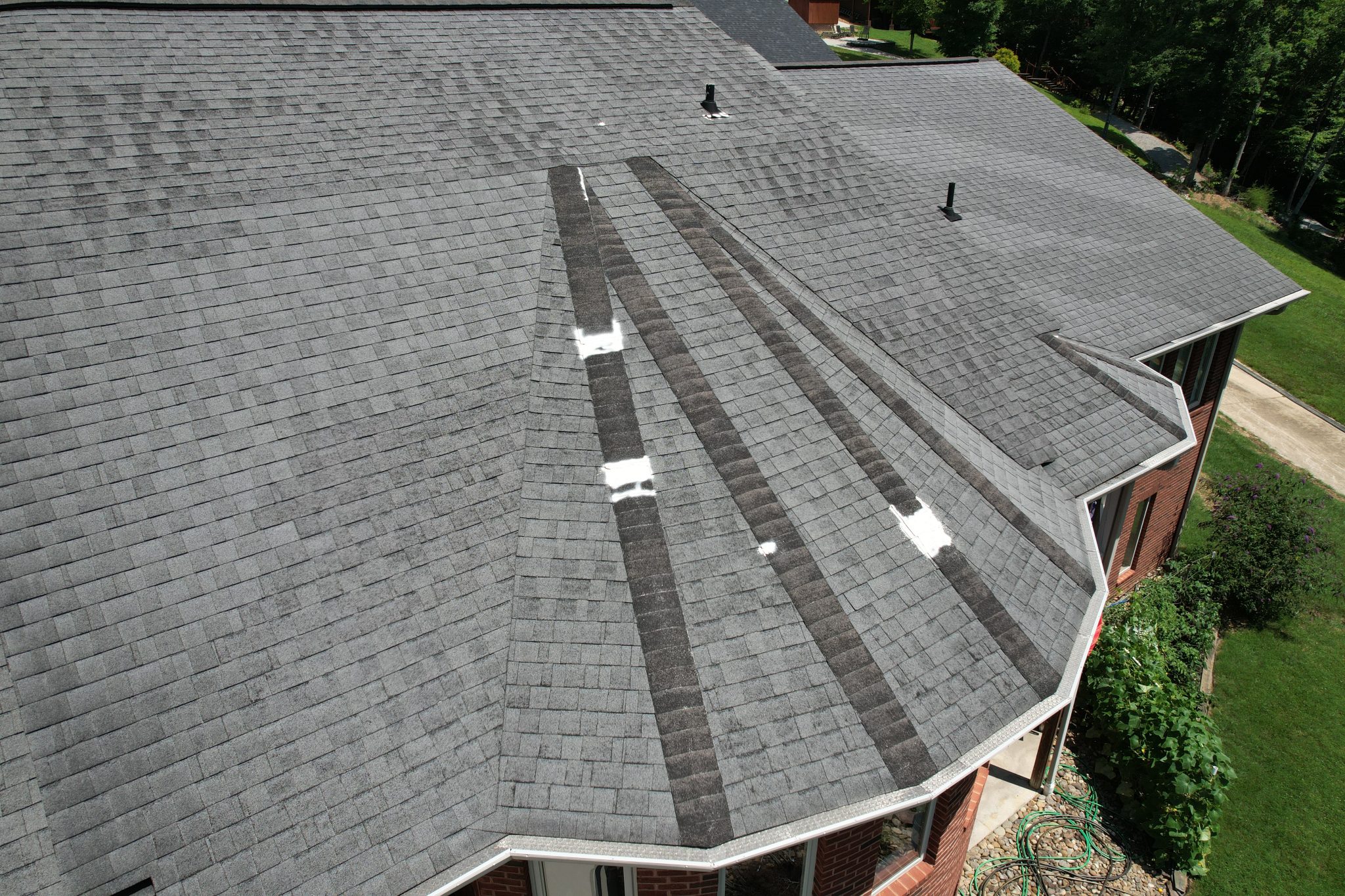 Before the Sharps Chapel Roof and Gutter Replacement Aging and patched roof before the Sharps Chapel roof and gutter replacement on a Norris Lake home.