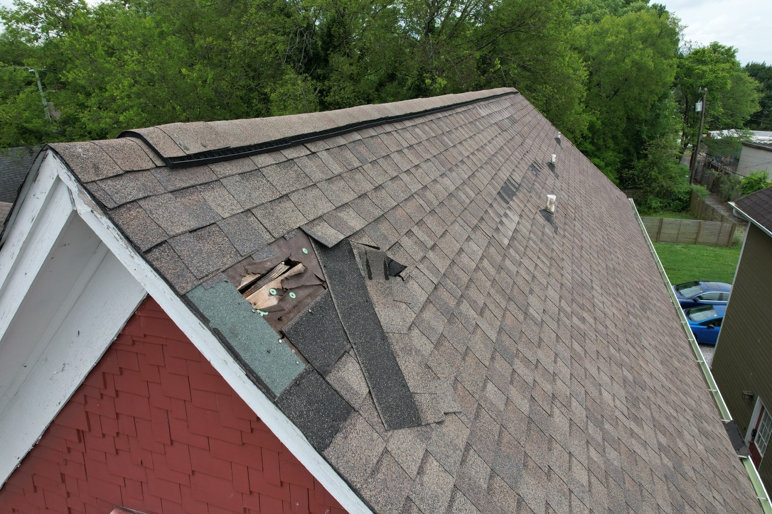 Serious Roof Decking Damage On A Downtown Knoxville Roof Damaged shingles and exposed aging plank decking on a Downtown Knoxville roof before OSB sheathing installation.
