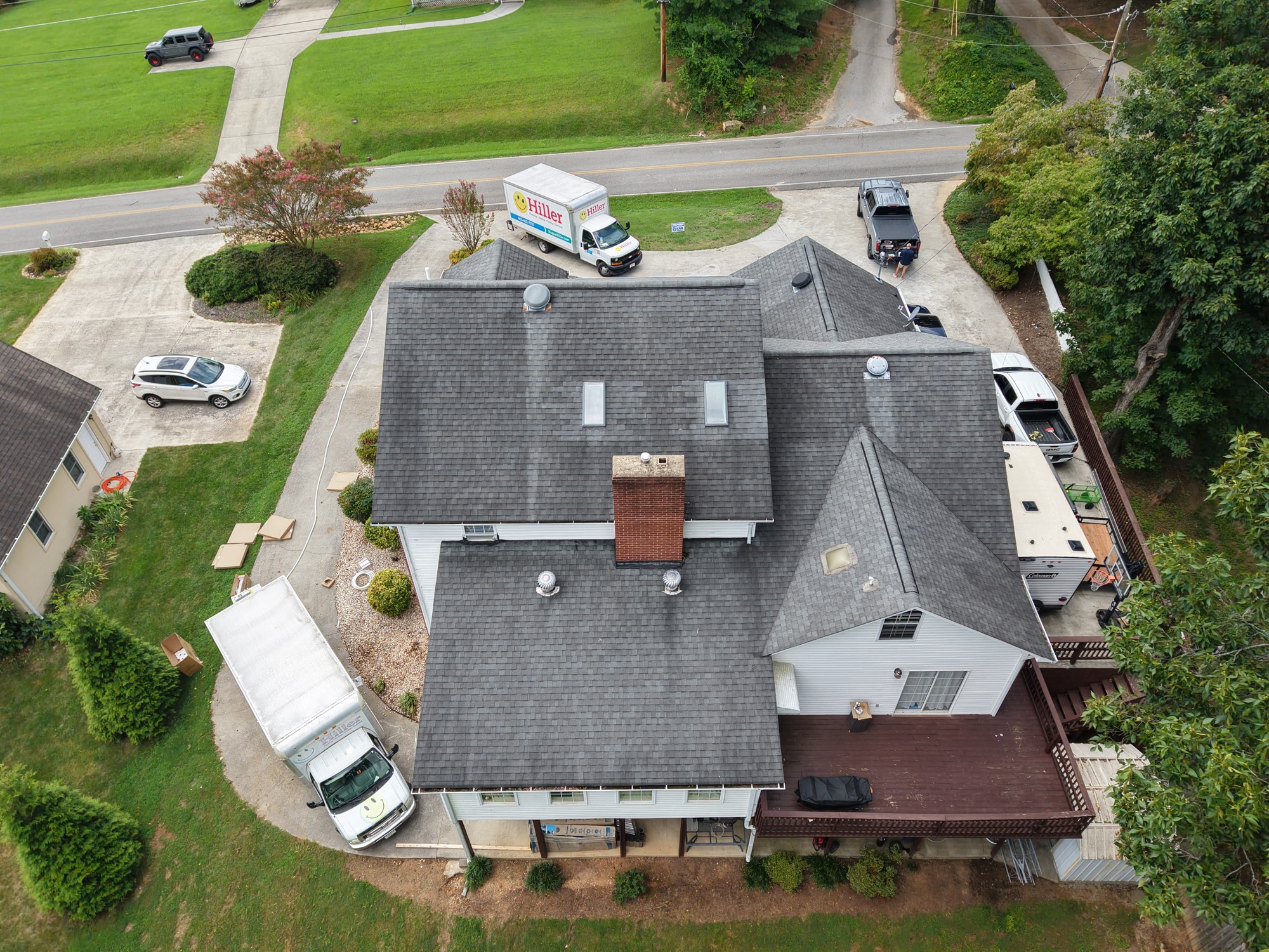 Overhead view of the original Farragut roof showing weathered gray shingles and uneven discoloration around the skylights and chimney.