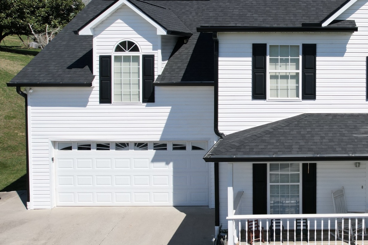 Front view of a white home with black gutters after gutter installation.