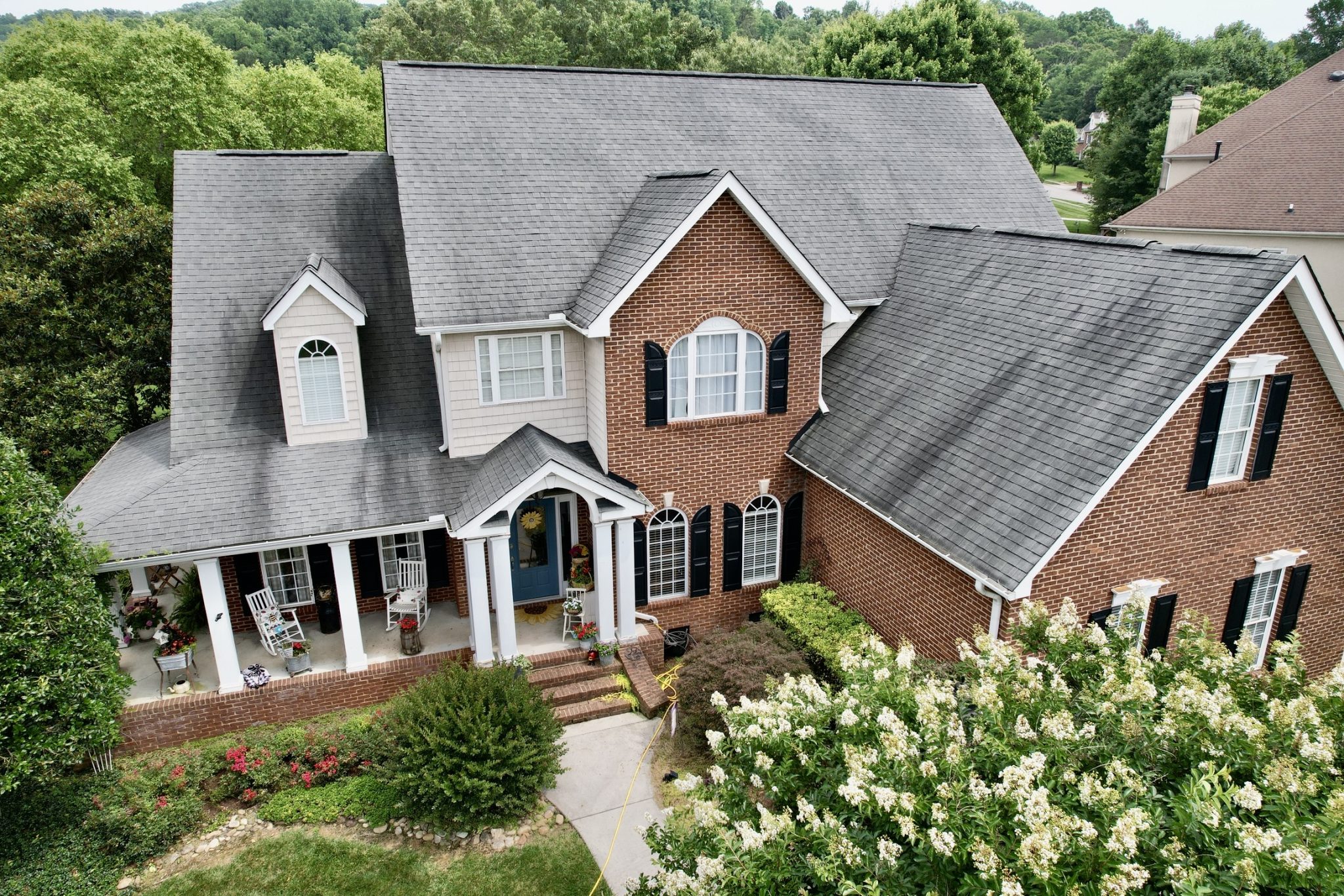 What Sun Exposure Does to Asphalt Shingles Over Time on a Knoxville Home Drone view of a Knoxville home showing what sun exposure does to asphalt shingles over time.