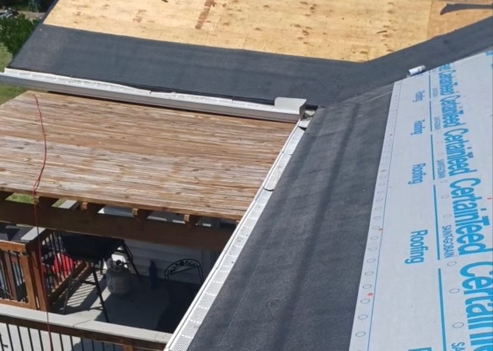 Roof Underlayment Installed During Asphalt Roof Replacement Roof underlayment being installed over roof decking during an asphalt roof replacement.
