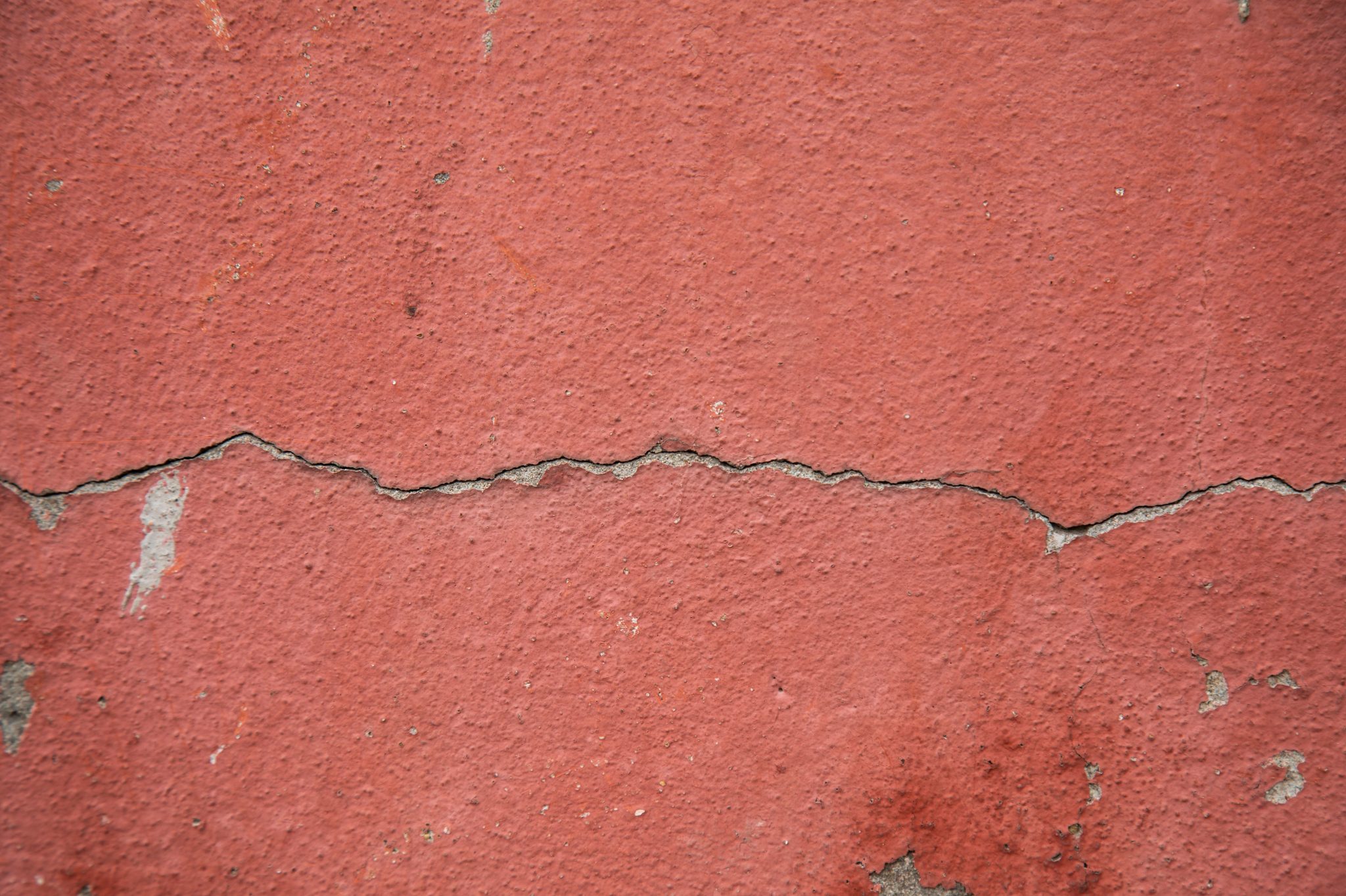 Crawl Space Moisture And Foundation Crack Warning Signs Cracked exterior foundation wall showing how poor drainage can contribute to crawl space moisture problems.