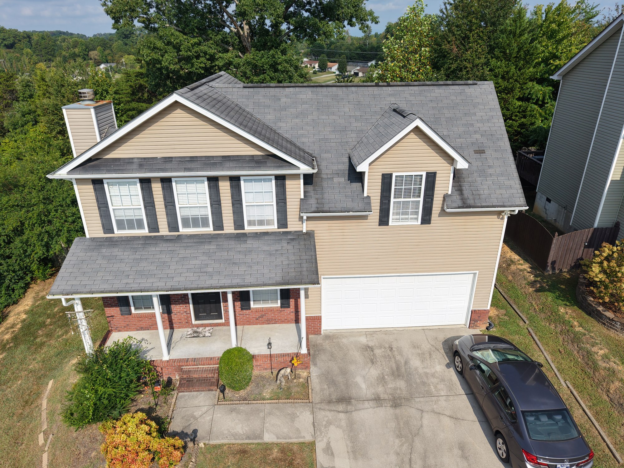 Before roof replacement Front aerial view of a two-story Powell home with gray shingles before roof replacement.