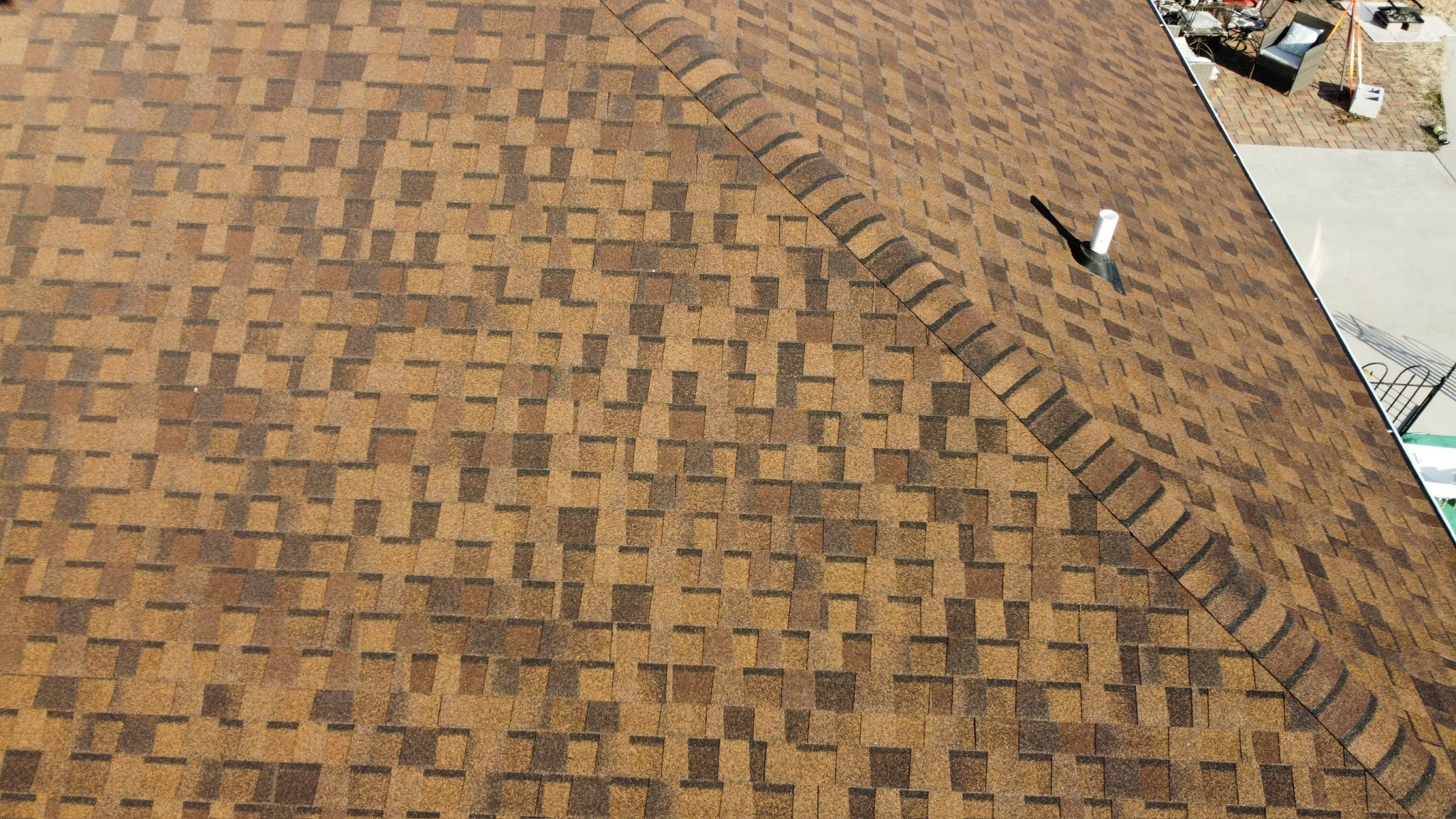 New roof with dimensional architectural shingles in warm brown tones.