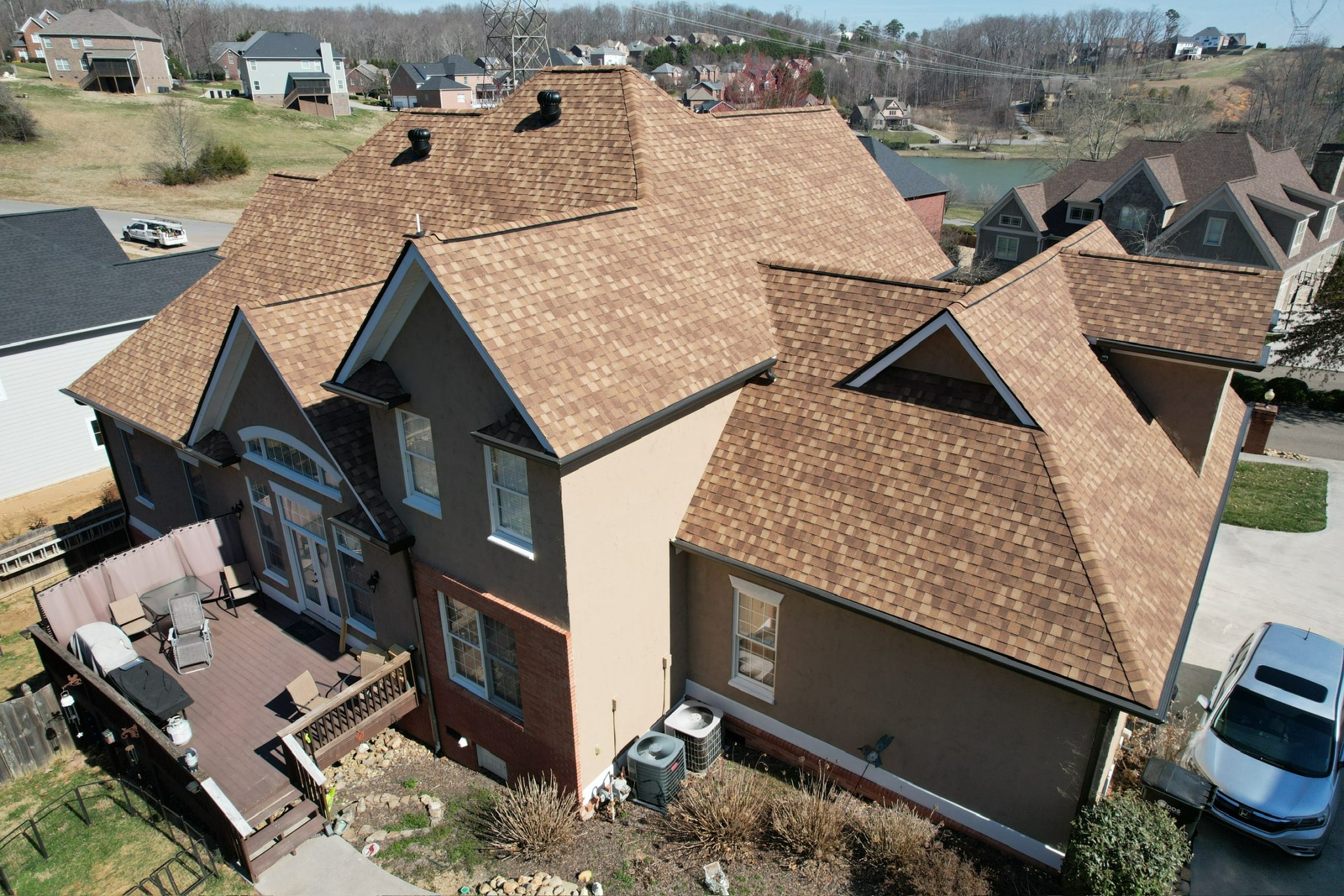 Aerial photo of a Knoxville home with a dimensional asphalt roof, used to illustrate architectural shingles vs. three-tab in our comparison guide.