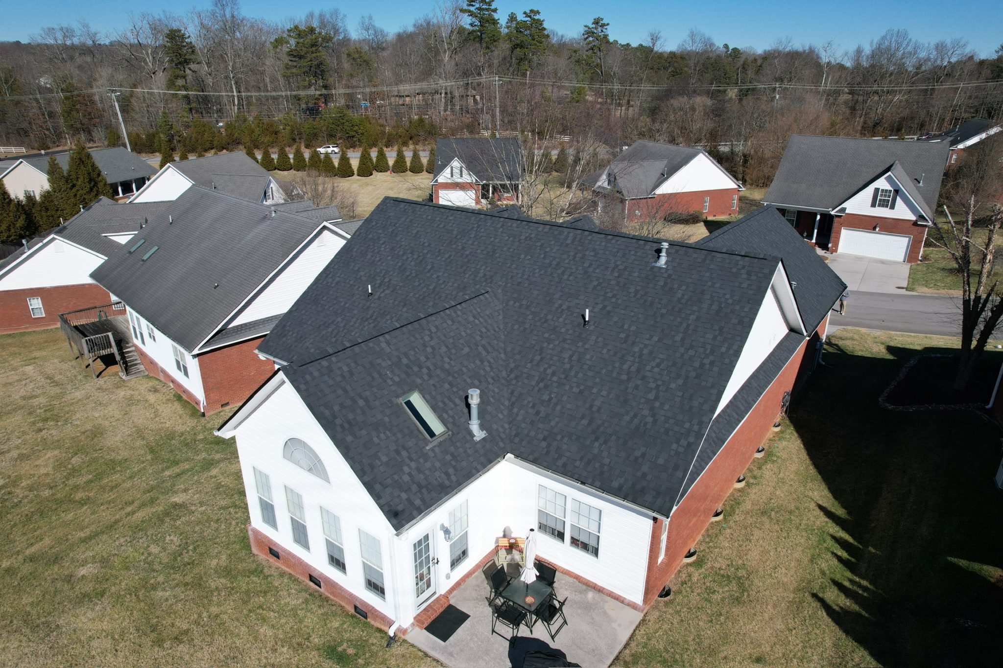 Asphalt Roofing Knoxville TN: What to Expect on Install Day Aerial view of a home with fresh asphalt shingles after an asphalt roofing knoxville tn install day.