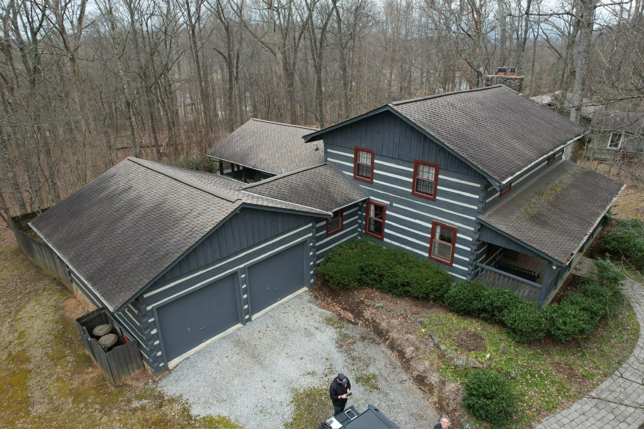Free roof inspection in Knoxville at a local home with an aging shingle roof shown from an aerial view.
