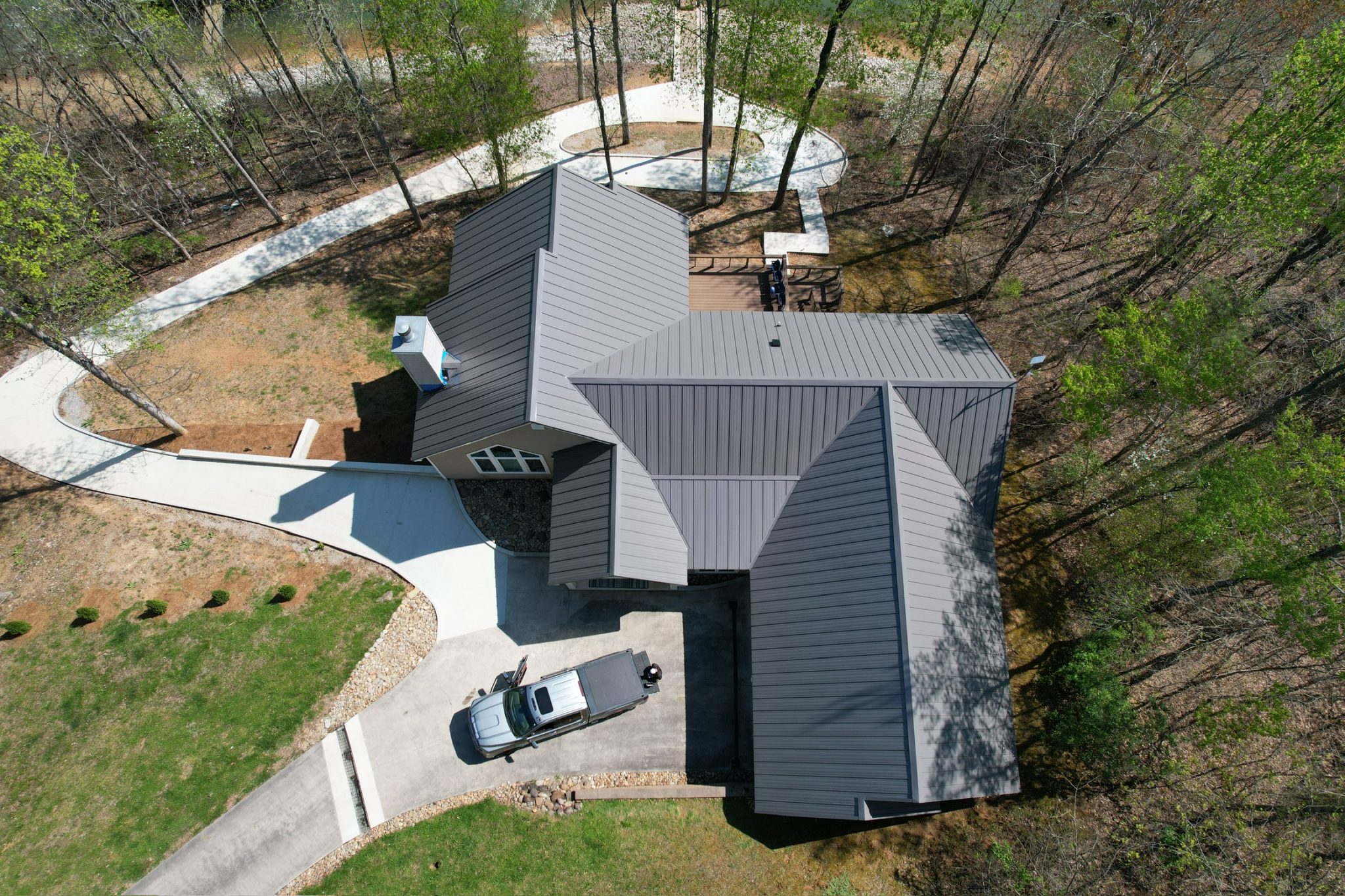 Aerial view of a Knoxville home with a gray metal roof, showing roof shape and pitch that can affect metal roof cost.