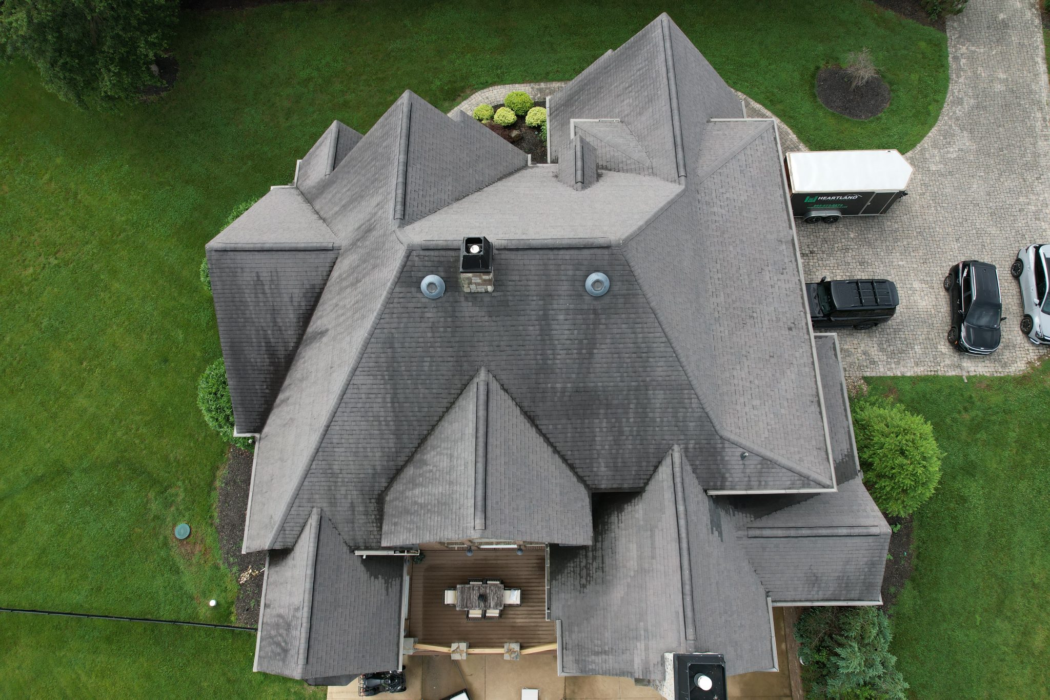 Before Steep-Slope Roof Replacement in Louisville, TN Aging shingles before a steep-slope roof replacement on a waterfront home in Louisville, TN.