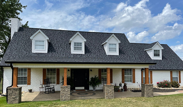 White house with shingles - new roof installation by Mountain View Exteriors